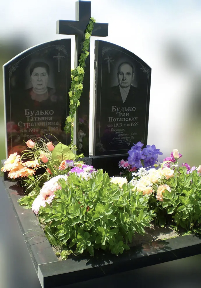 Подвійний памʼятник із чорного каменю з хрестом